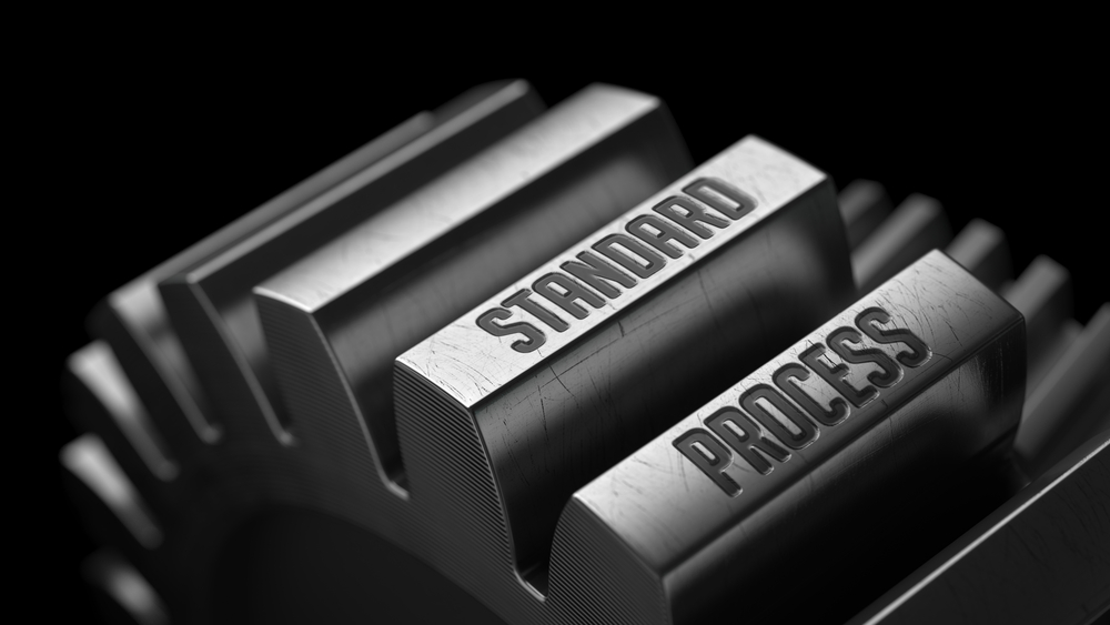 Standard Process on the Metal Gears on Black Background.